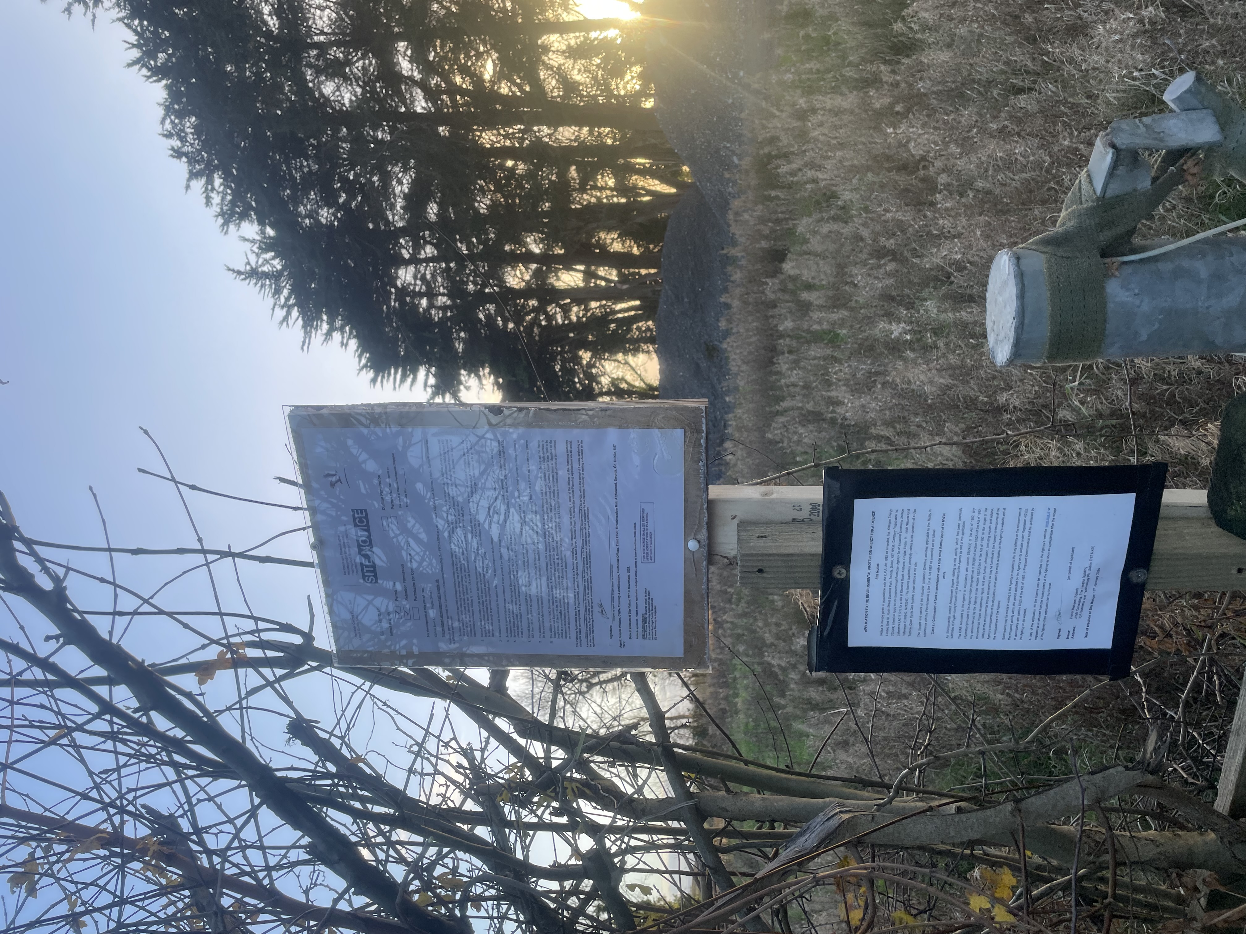 Site notice erected on post at sunset