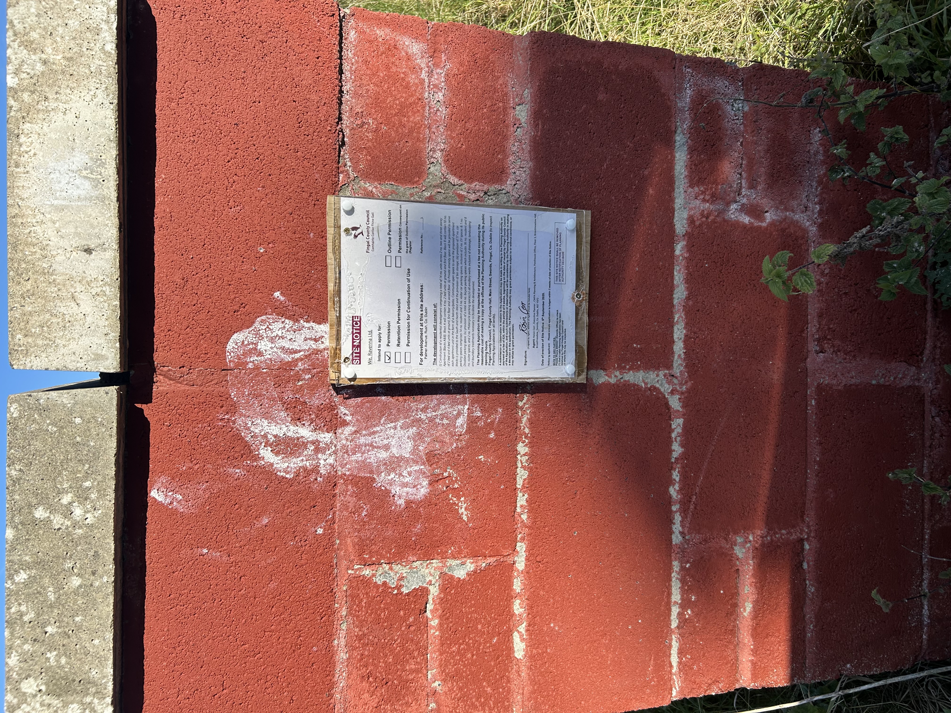 Site notice at night on gate post
